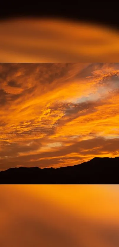 Orange sunset over mountains with dramatic clouds.