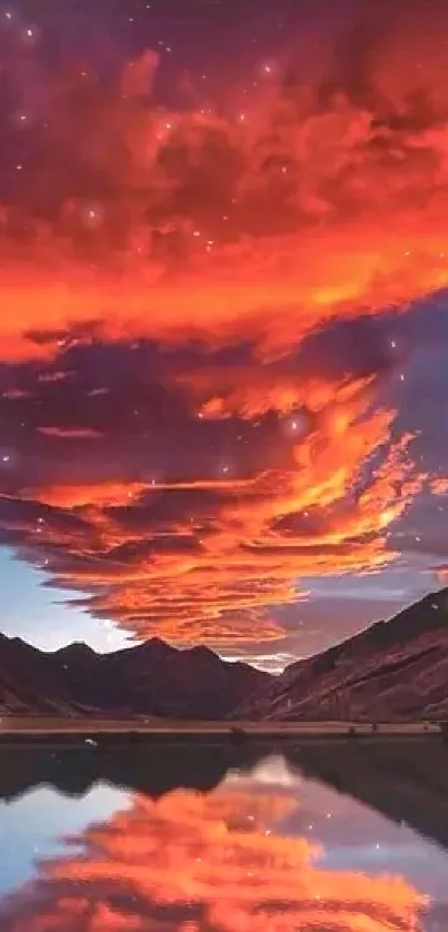 Fiery orange sunset reflecting over mountain scenery with a serene lake.