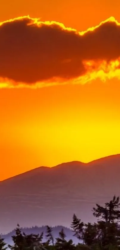 Vibrant orange sunset over mountain silhouette.