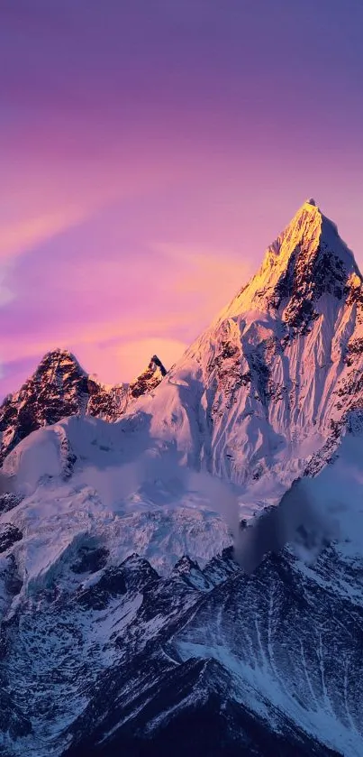 Snow-capped mountain under pink-purple sunset glow.