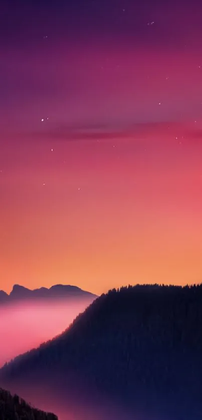 Vivid sunset over misty mountains with a purple and orange night sky.