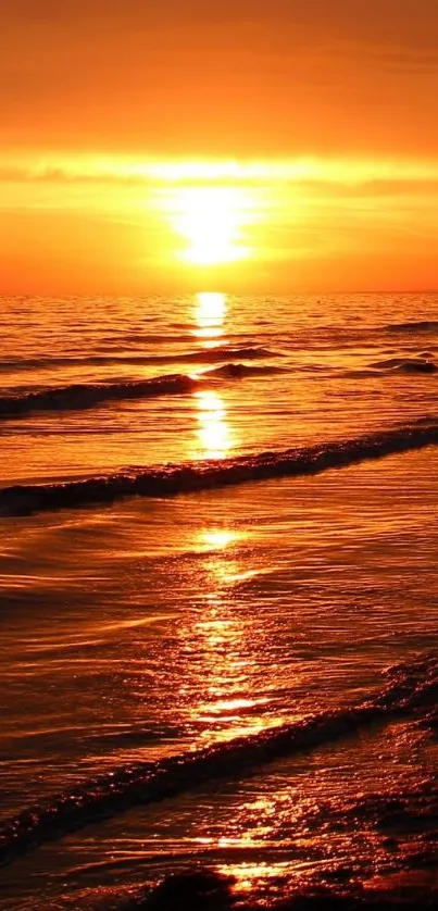 Vibrant sunset over ocean waves with shimmering orange glow.