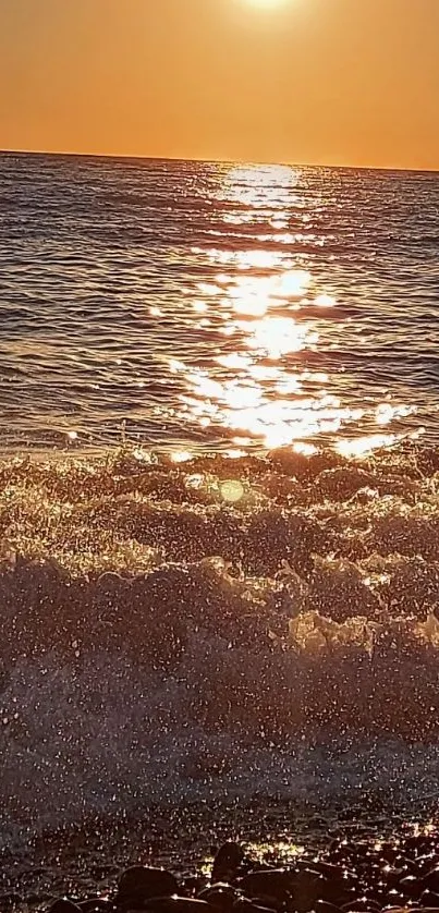 A beautiful sunset over the ocean with gentle waves and shimmering water.