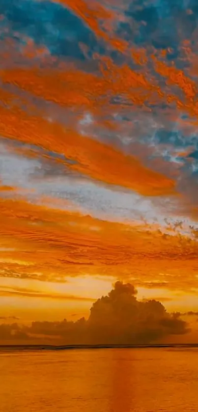 Beautiful sunset over calm ocean with vibrant orange sky and clouds.