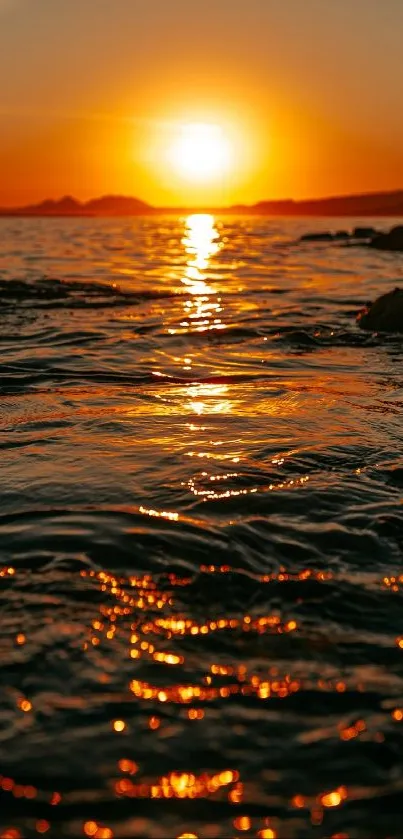 Beautiful sunset over ocean with golden reflections on water.