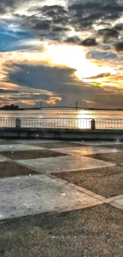 Beautiful sunset scene over a bridge with vibrant colors and calm waters.