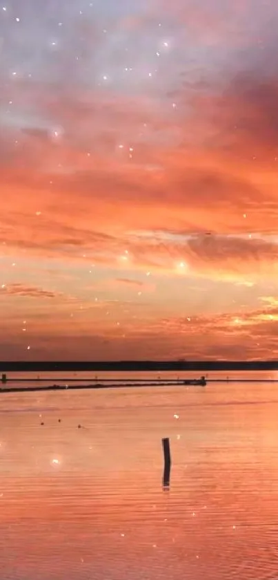 Brilliant orange sunset reflecting on calm waters.