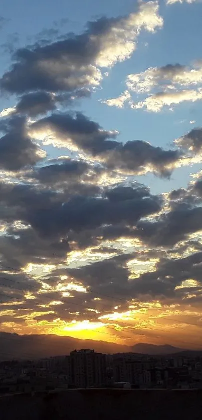 Stunning sunset over city skyline with dramatic clouds and glowing sky.