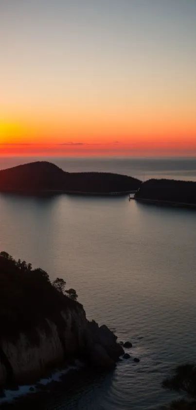 Serene mobile wallpaper with sunset over bay and ocean.