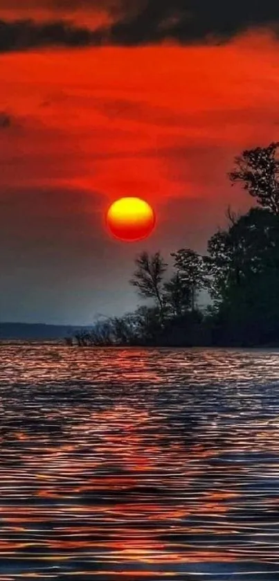 Stunning red and orange sunset over calm water.