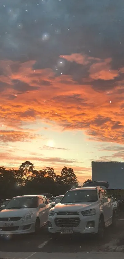 Breathtaking sunset over parking lot with cars and vibrant sky.