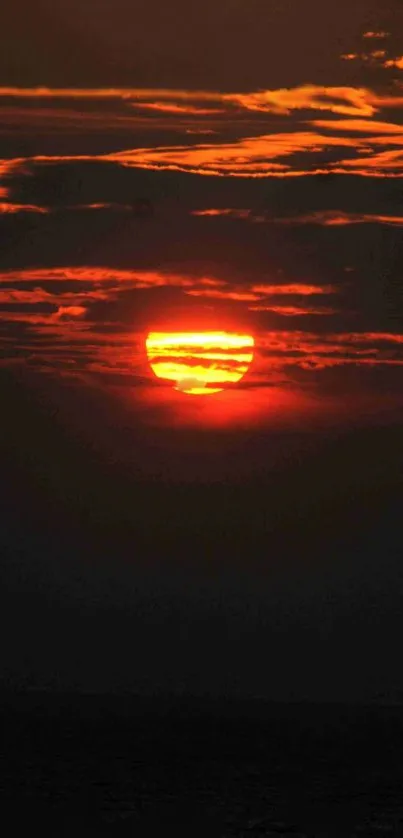 Vibrant orange sunset with dark clouds and sun rays on phone wallpaper.