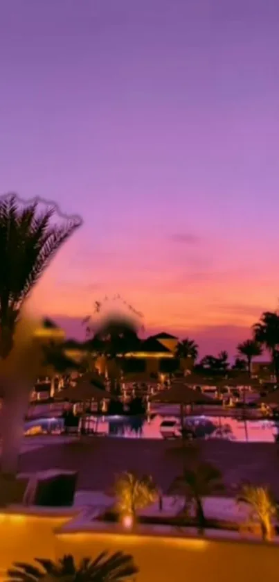 Stunning sunset resort view with purple and pink sky over a poolside setting.