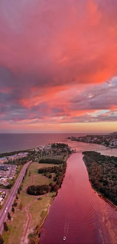 Aerial view of sunset over a river with pink and orange sky.