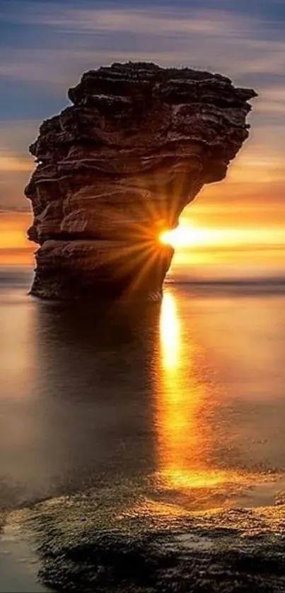 Sunset illuminating a rock formation over the ocean, perfect for mobile wallpaper.