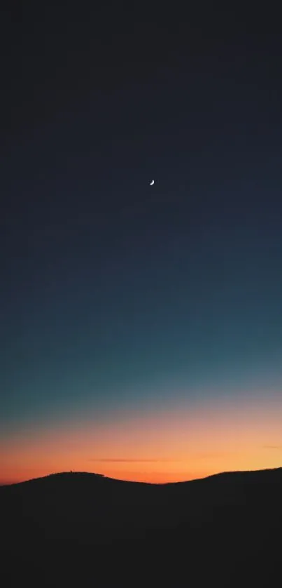 Calm sunset over hills with a navy blue sky.