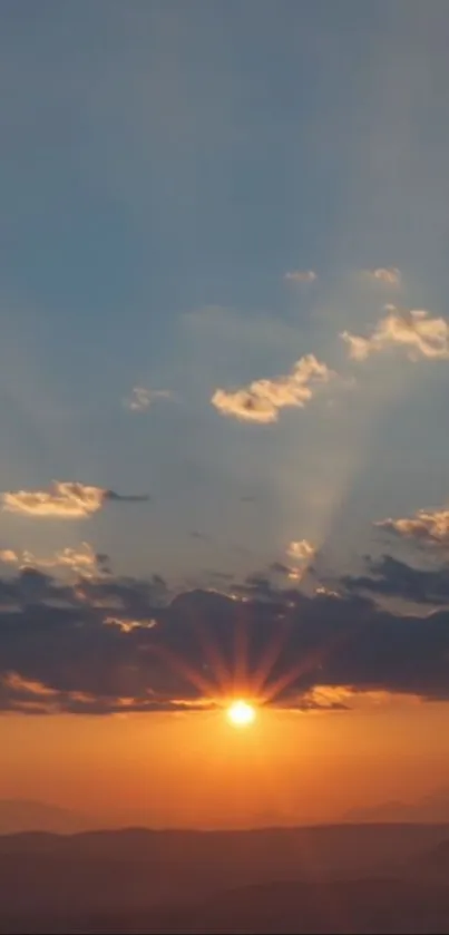 A peaceful sunset with orange skies and silhouetted clouds.