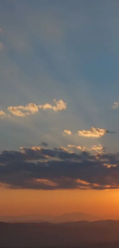 Sunset over mountains with vibrant sky.