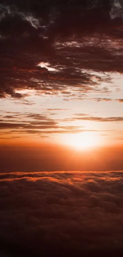 Sunset over clouds with a vibrant orange sky.