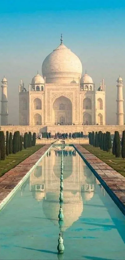 Stunning view of the Taj Mahal reflecting in a serene pool under a blue sky.