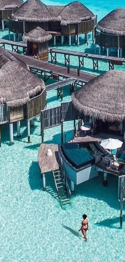 Overwater villas in clear tropical water with a seaside walkway.