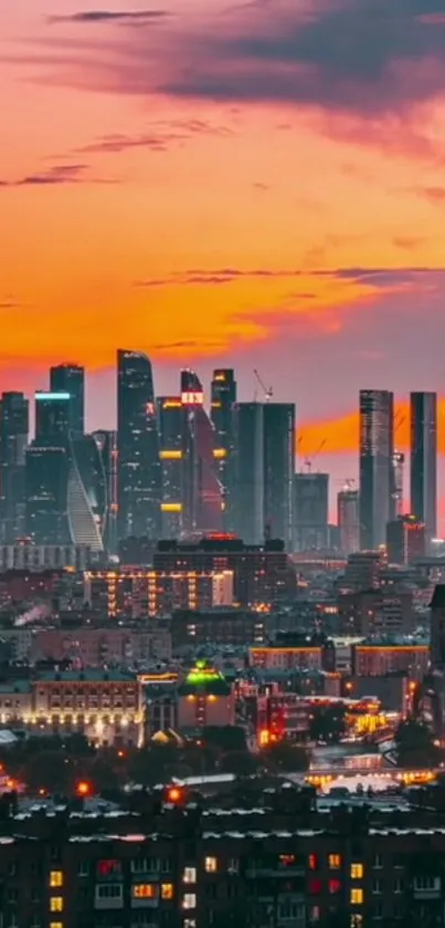 Orange sunset over a city skyline with skyscrapers and city lights.