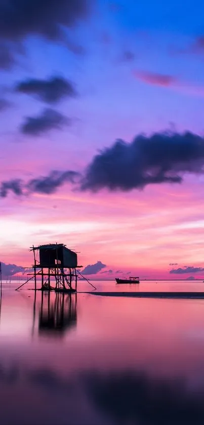 Vibrant sunset with purple skies reflected on calm waters, featuring a tranquil scene.