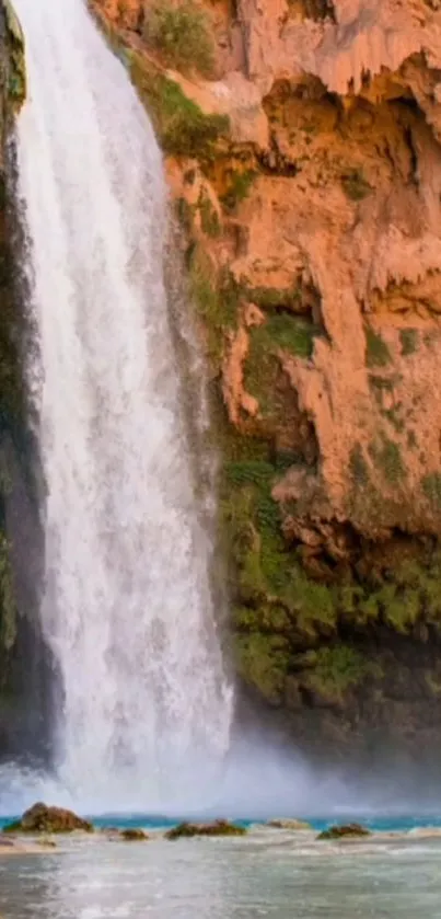 Majestic waterfall in canyon with lush greenery, perfect serene wallpaper.