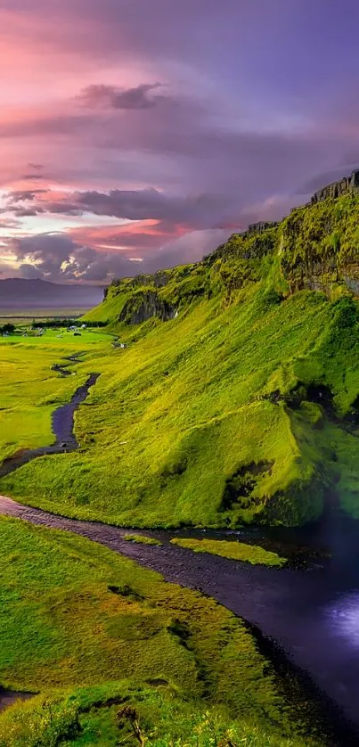 Mobile wallpaper of a vibrant waterfall in a green landscape at sunset.