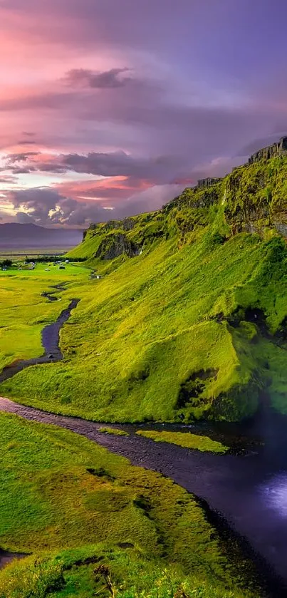 Breathtaking waterfall flowing into lush green landscape under vibrant sunset.