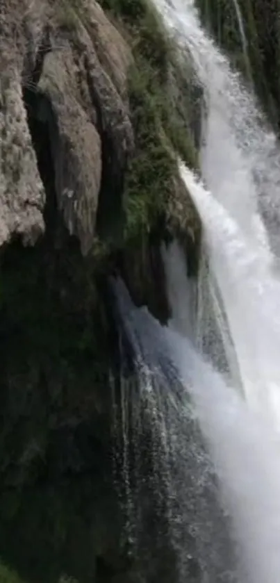 Stunning waterfall cascading over rugged cliffs and lush greenery.