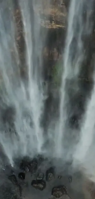 A majestic waterfall cascading down a rocky cliff, creating a peaceful and natural scene.