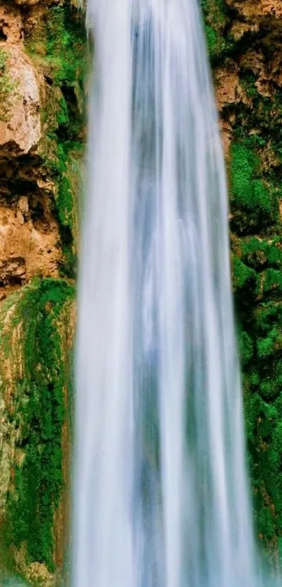 Majestic waterfall cascading down lush green cliffs.