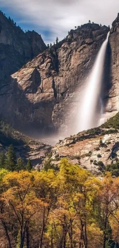 Breathtaking waterfall cascading down cliffs with vibrant foreground foliage.