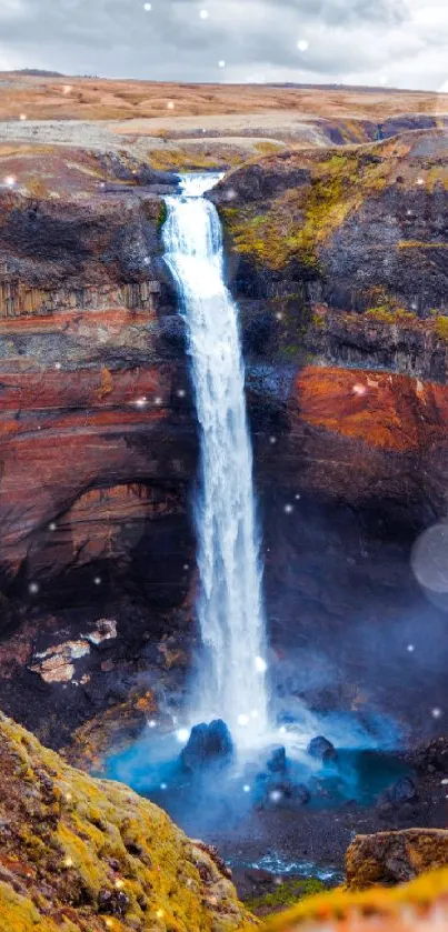 Majestic waterfall in a scenic landscape with a blue pool.