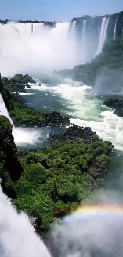 Scenic waterfall with rainbow and lush greenery in a serene landscape.