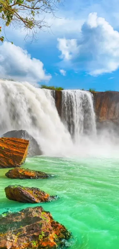 Majestic waterfall with turquoise water under a clear blue sky.