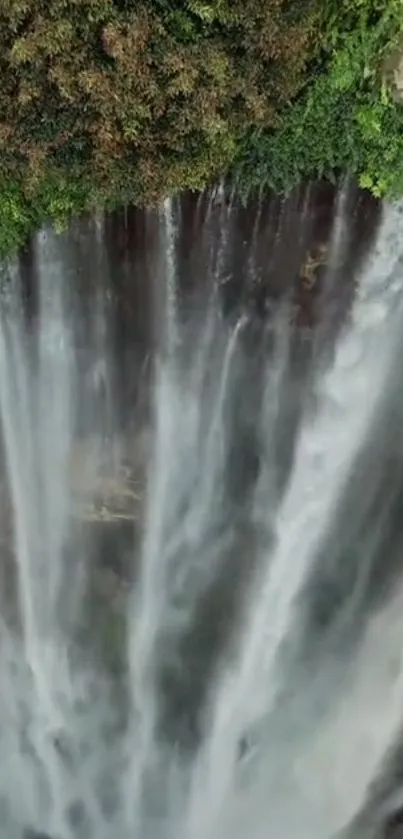 A stunning waterfall surrounded by lush greenery cascading down into serene waters.