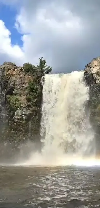 Majestic waterfall with rainbow in nature wallpaper.