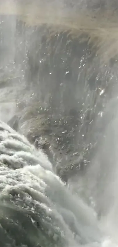 Serene waterfall with mist and flowing waters creating a tranquil scene.