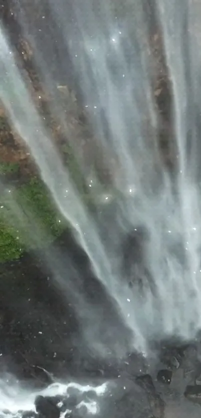 Cascading waterfall with lush greenery.