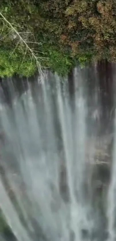 Beautiful cascade of a waterfall with lush green surroundings.