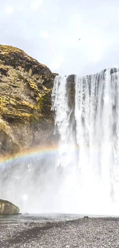 Majestic waterfall with vibrant rainbow scene.