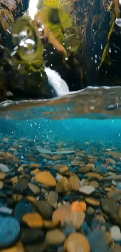 Calming underwater view with waterfall and vibrant pebbles.