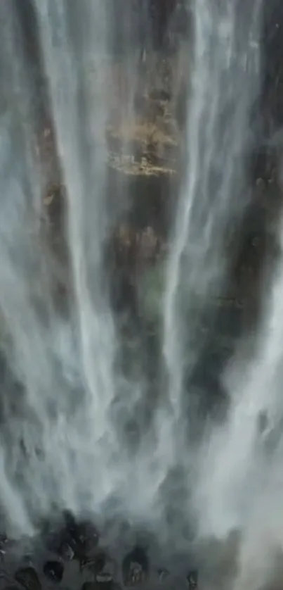 Beautiful vertical waterfall portraying serene cascading water down the rocks.