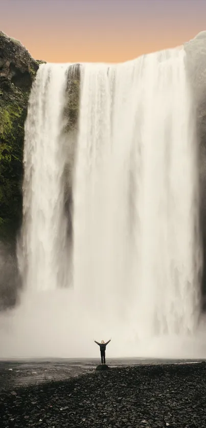 Waterfall with lush greenery and a serene atmosphere for mobile wallpaper.