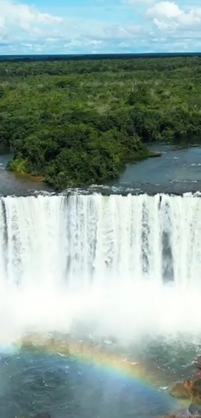 Majestic waterfall with a rainbow over lush greenery.