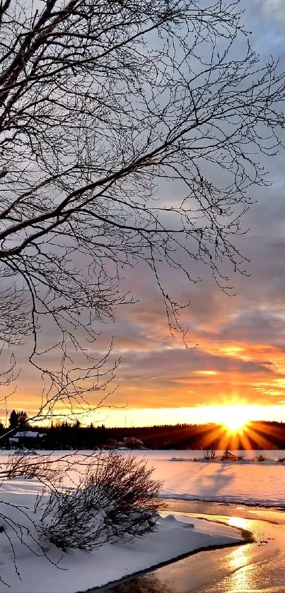 Winter sunset over snowy landscape and river.