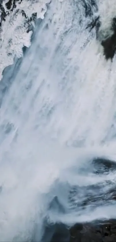 Dynamic waterfall with surrounding ice in a winter landscape.