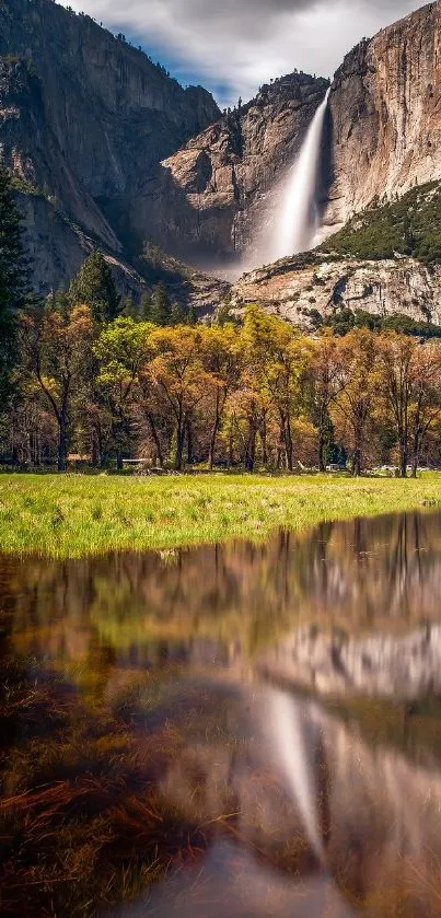 Yosemite waterfall with green meadow and reflective pond